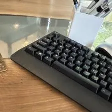 Customer photo from Sandy of our Sharpie S-Gel Pen, a hand holding a pen next to a keyboard