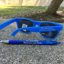 Customer photo from Ann of our VP Gel Pen, a blue sunglasses and a pen on a concrete surface