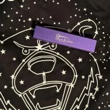 Customer photo from Diane of our Cell Phone Power Bank, a purple rectangular object on a black shirt