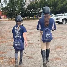 Customer photo from Rose of our Polypropylene Sportpack - 24 hr, two girls wearing helmets and riding helmets walking down a road