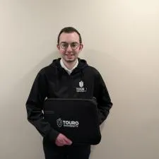 Customer photo from Eli of our Walker Laptop Sleeve - 13 inches - 24 hr, a man holding a black bag