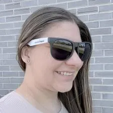 Customer photo from Jenna of our Spirit Rally Towel - 24 hr, a woman wearing sunglasses and smiling