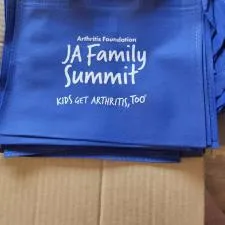 Customer photo from Tamara of our Mini Non-Woven Flat Tote, a pile of blue bags