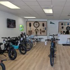 Customer photo from Jerry of our Branded Bills Bare Curved Performance Cap, a room with bicycles and a table